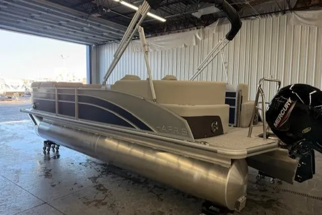 Slide: The Image of 2025 Harris Cruiser 230 CWDH pontoon boat in a warehouse setting. - 9
