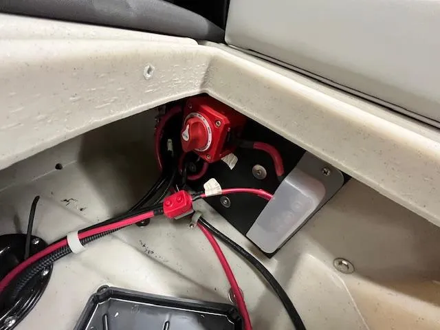 Slide: The Image of 2025 Harris Cruiser 210 boat battery compartment with wiring and switch. - 22