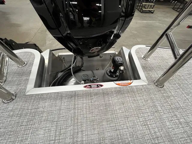 Slide: The Image of 2025 Harris Cruiser 210 boat engine compartment with controls and wiring. - 4