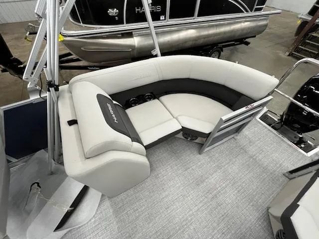 Slide: The Image of 2025 Harris Cruiser 210 pontoon boat interior with curved seating and modern design. - 5