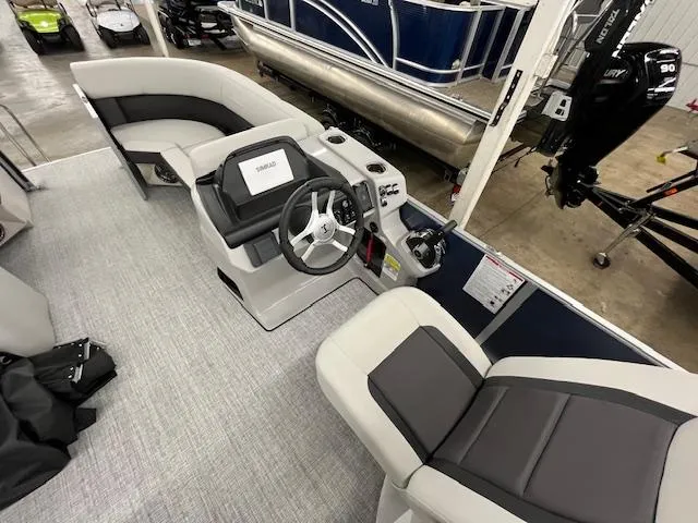 Slide: The Image of 2025 Harris Cruiser 210 boat interior with modern seating and steering console. - 8