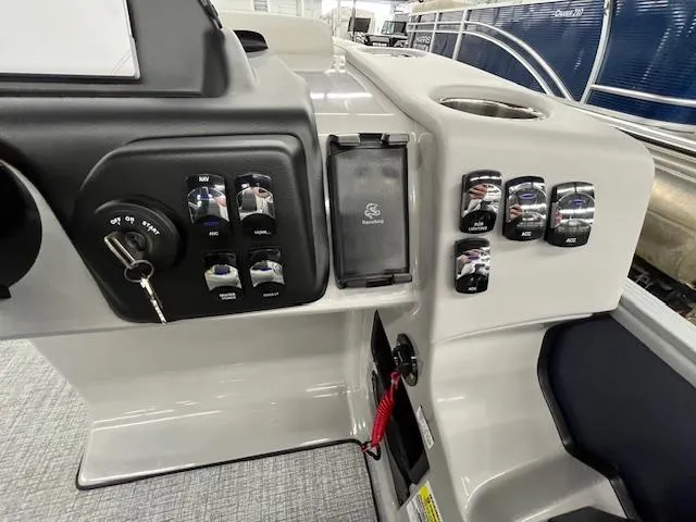 Slide: The Image of Control panel of 2025 Harris Cruiser 210 boat with switches and key ignition. - 9