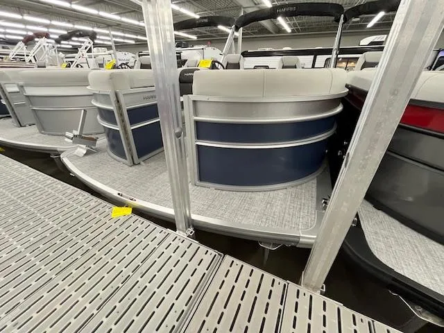 The Image of 2025 Harris Cruiser 210 pontoon boat displayed in a showroom. - 0