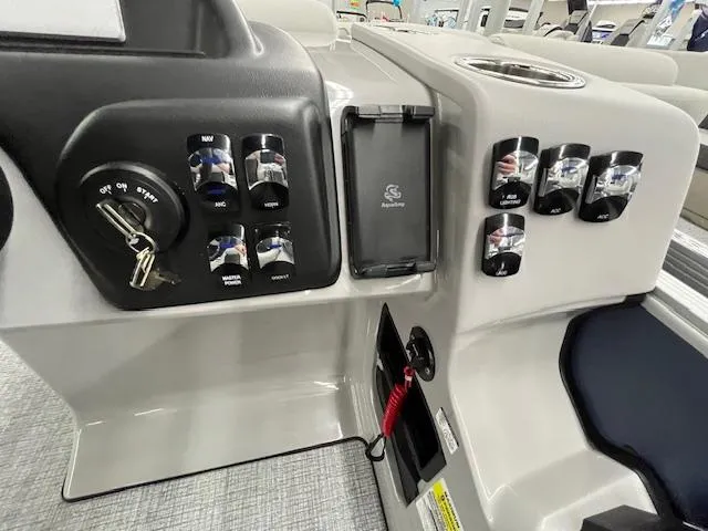 Slide: The Image of Control panel of 2025 Harris Cruiser 210 boat with ignition and switches. - 24