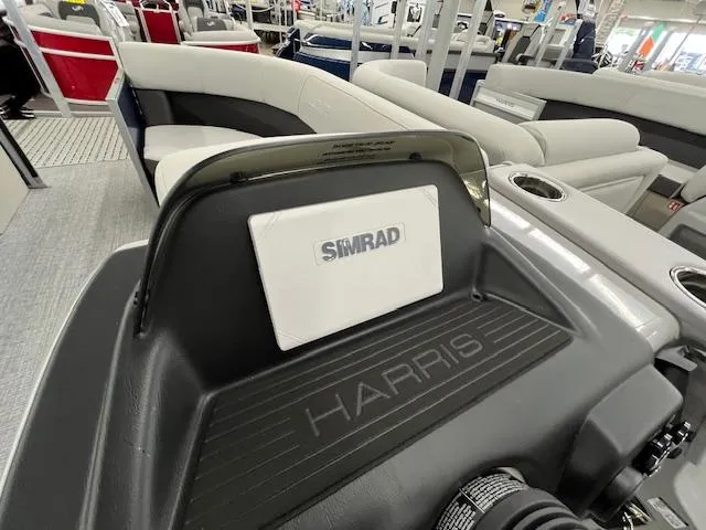 Slide: The Image of 2025 Harris Cruiser 210 boat interior with Simrad navigation system and comfortable seating. - 25