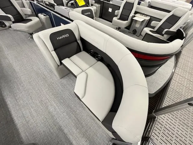 Slide: The Image of 2025 Harris Cruiser 210 boat interior with plush seating and cup holders. - 8