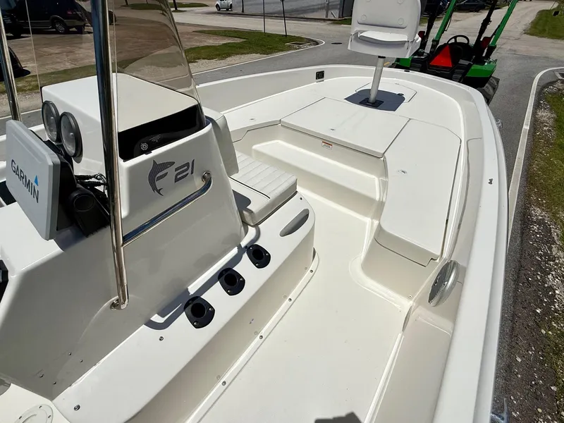 Slide: The Image of 2020 Bayliner Element F21 boat interior with Garmin equipment, featuring seating and storage areas. - 14