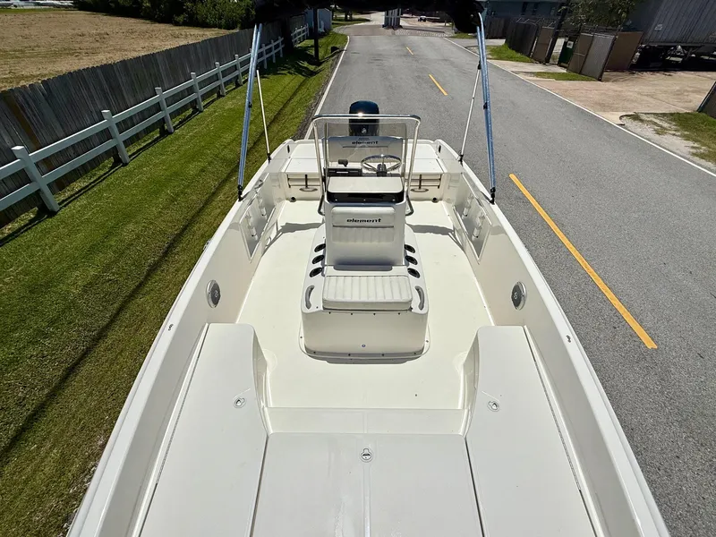 Slide: The Image of 2020 Bayliner Element F21 boat on road, showcasing spacious deck and seating. - 15