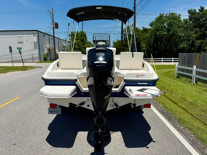 Slide: The Image of 2020 Bayliner Element F21 boat on a road, rear view with outboard motor. - 3
