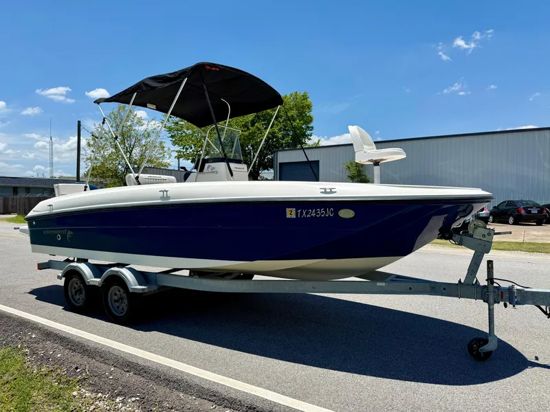 Slide: The Image of 2020 Bayliner Element F21 boat on trailer, blue hull, parked outdoors under clear sky. - 5