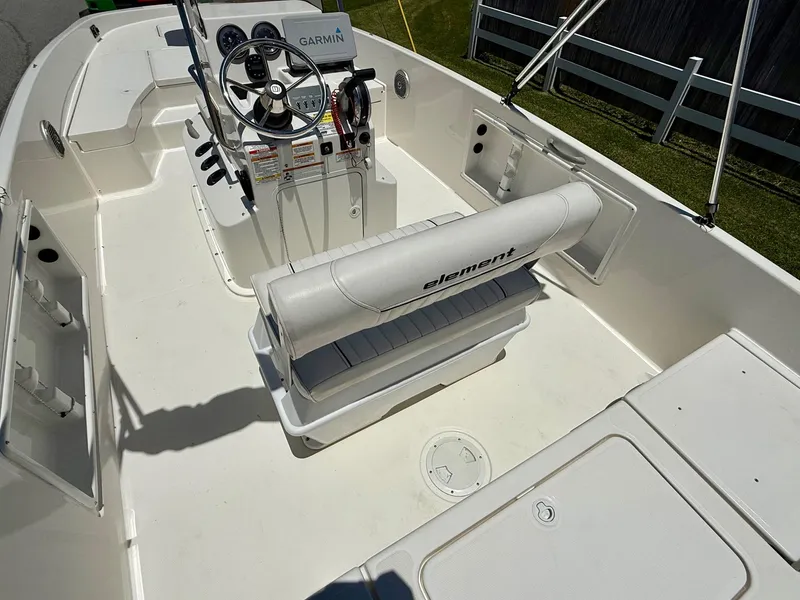 Slide: The Image of 2020 Bayliner Element F21 boat interior with Garmin navigation system and seating. - 9