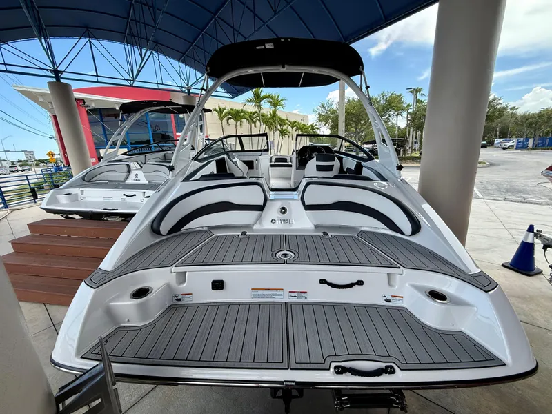 Slide: The Image of 2025 Yamaha Boats 195S with sleek design and spacious seating under a canopy. - 5
