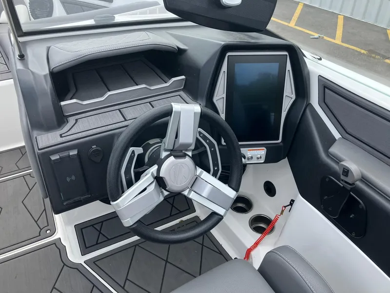 Slide: The Image of 2023 Tigé Z1 boat dashboard with modern steering wheel and touchscreen display. - 12