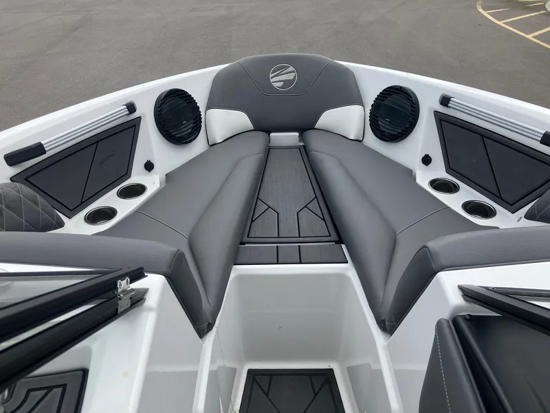 Slide: The Image of 2023 Tigé Z1 boat interior with gray seating, cup holders, and speakers. - 13