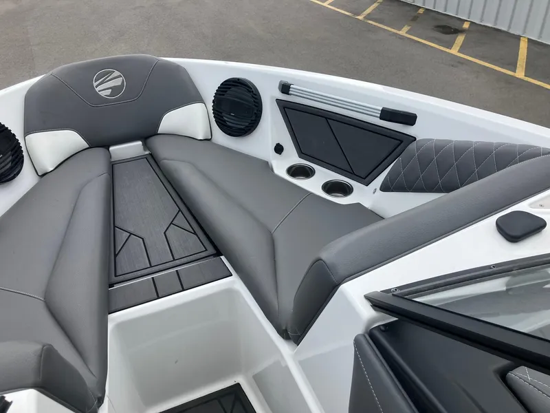 Slide: The Image of 2023 Tigé Z1 boat interior with gray seating, cup holders, and speakers. - 14