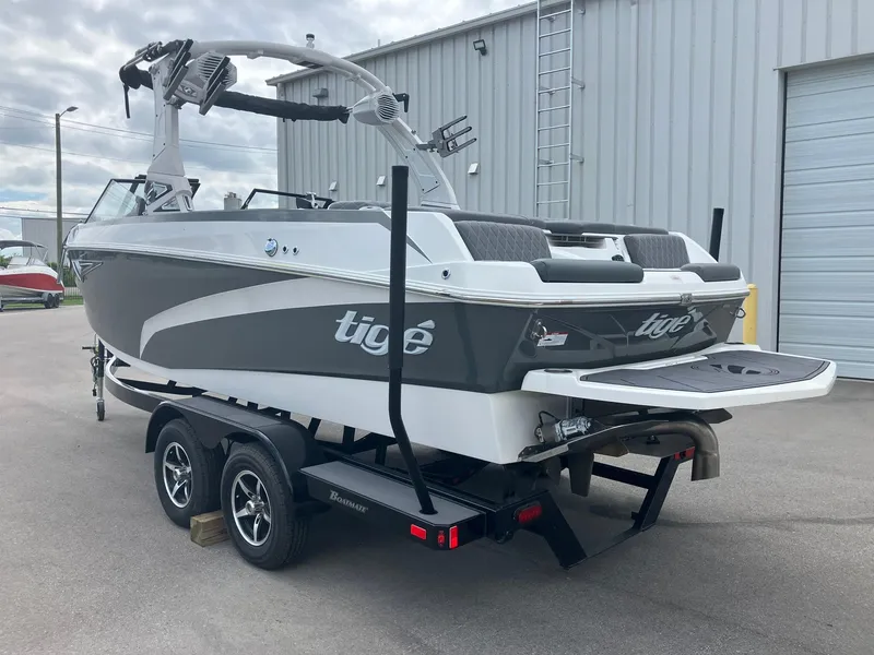 Slide: The Image of 2023 Tigé Z1 boat on trailer, parked outside a warehouse. - 4