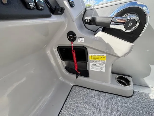 Slide: The Image of 2025 Harris Cruiser 210 boat dashboard with controls, ignition, and safety features. - 10