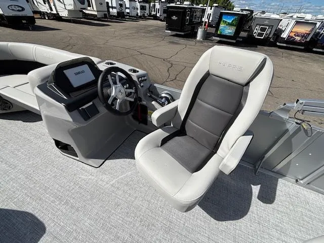 Slide: The Image of 2025 Harris Cruiser 210 boat interior with steering wheel and captain's chair. - 11