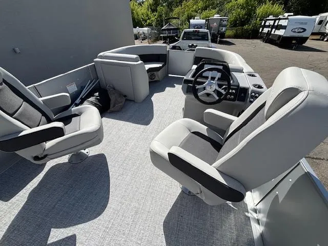 Slide: The Image of 2025 Harris Cruiser 210 boat interior with plush seating and modern steering console. - 12