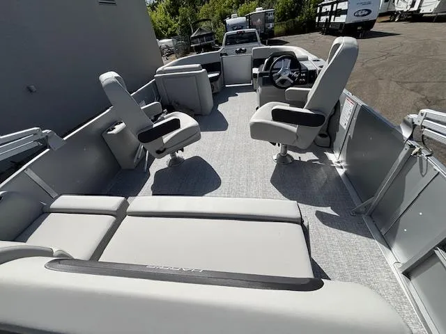 Slide: The Image of 2025 Harris Cruiser 210 pontoon boat interior with gray seating and steering console. - 13