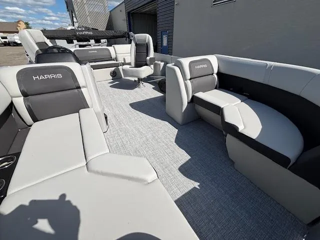 Slide: The Image of 2025 Harris Cruiser 210 pontoon boat with spacious seating and modern design. - 22