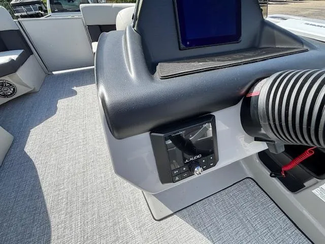 Slide: The Image of 2025 Harris Cruiser 210 boat dashboard with JL Audio system and modern controls. - 7
