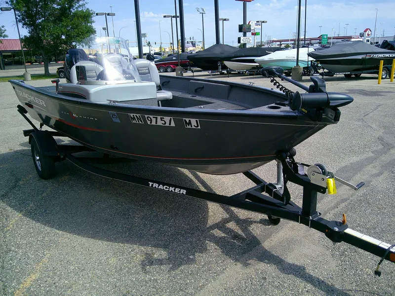 Slide: The Image of 2017 Tracker Pro Guide V-16 SC boat on trailer in parking lot. - 2