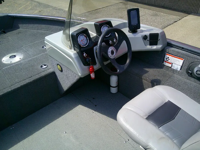 Slide: The Image of 2017 Tracker Pro Guide V-16 SC boat interior with steering wheel and dashboard controls. - 5