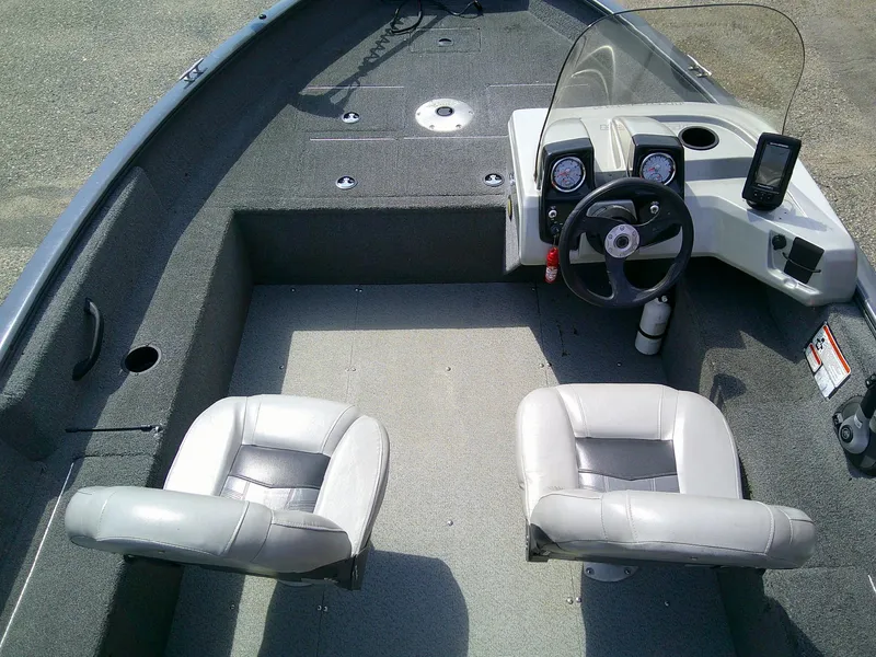 Slide: The Image of 2017 Tracker Pro Guide V-16 SC boat interior with steering console and two seats. - 6
