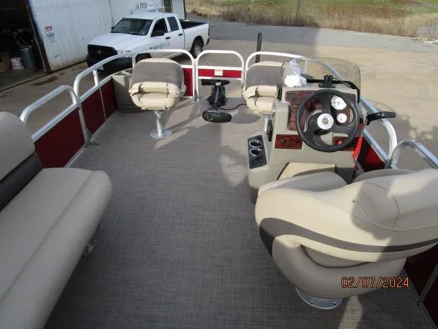 Slide: The Image of 2023 Sun Tracker Bass Buggy pontoon boat interior with seating and steering console. - 6