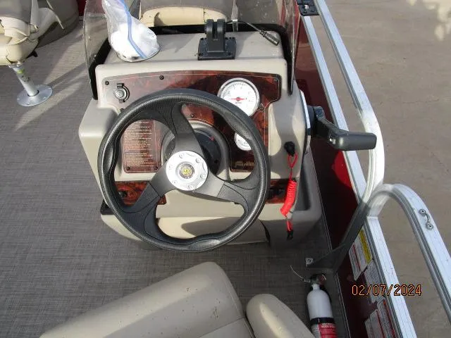 Slide: The Image of 2023 Sun Tracker Bass Buggy steering console with gauges and controls. - 7