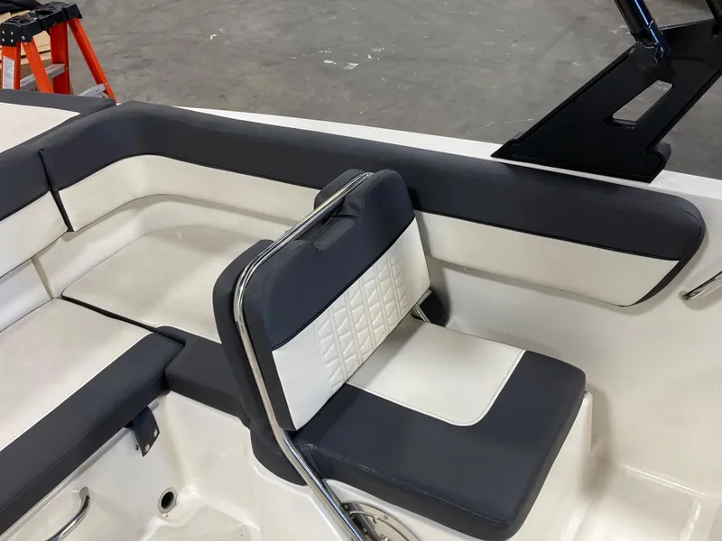 Slide: The Image of 2020 Bayliner VR6 boat interior with cushioned seating and sleek design. - 10