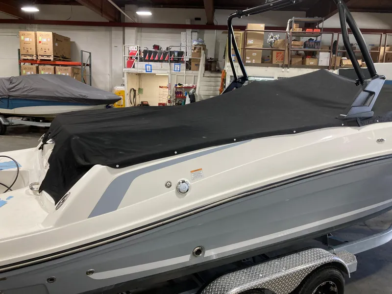 Slide: The Image of 2020 Bayliner VR6 boat with black cover in a storage facility. - 14