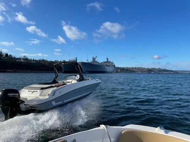 Slide: The Image of 2020 Bayliner VR6 speedboat cruising on open water under a clear blue sky. - 22