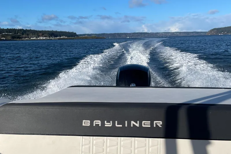 Slide: The Image of Bayliner VR6 2020 boat cruising on open water, leaving a wake behind. - 25
