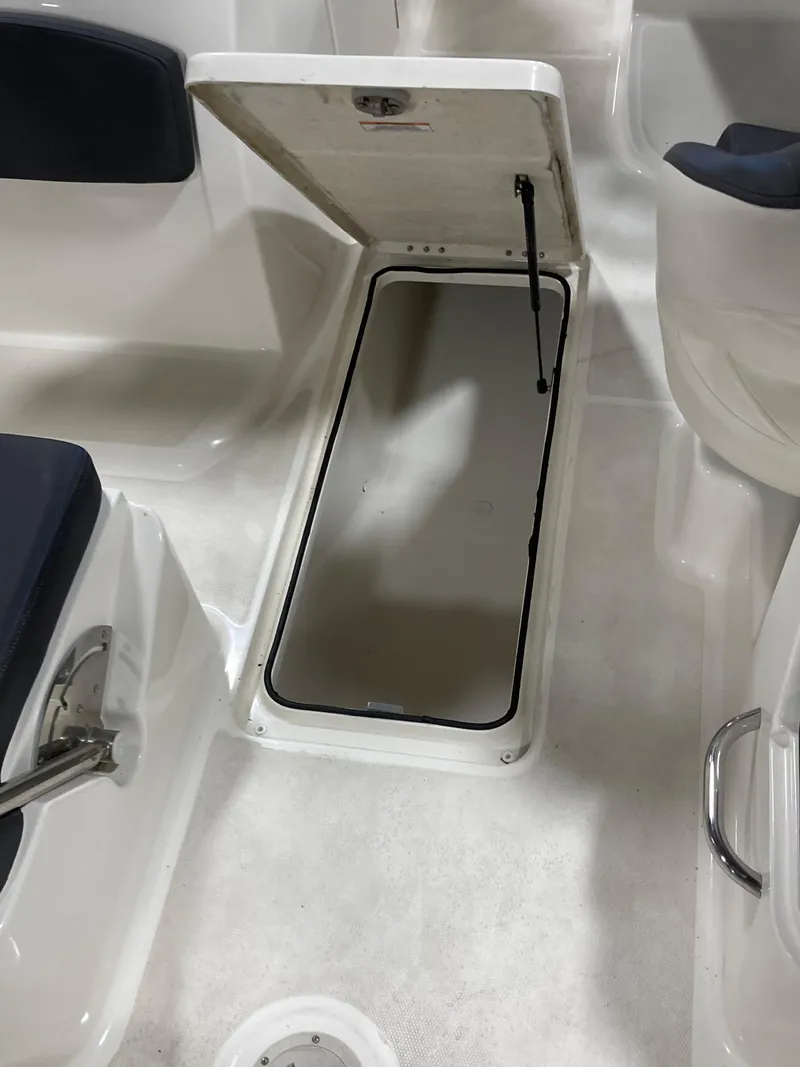Slide: The Image of Open storage compartment on 2020 Bayliner VR6 boat interior. - 5