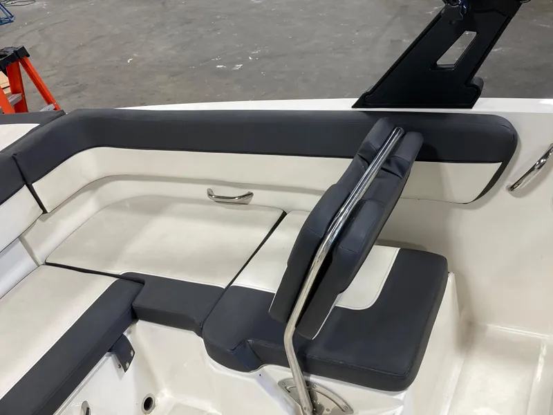 Slide: The Image of 2020 Bayliner VR6 boat interior seating with black and white upholstery. - 8