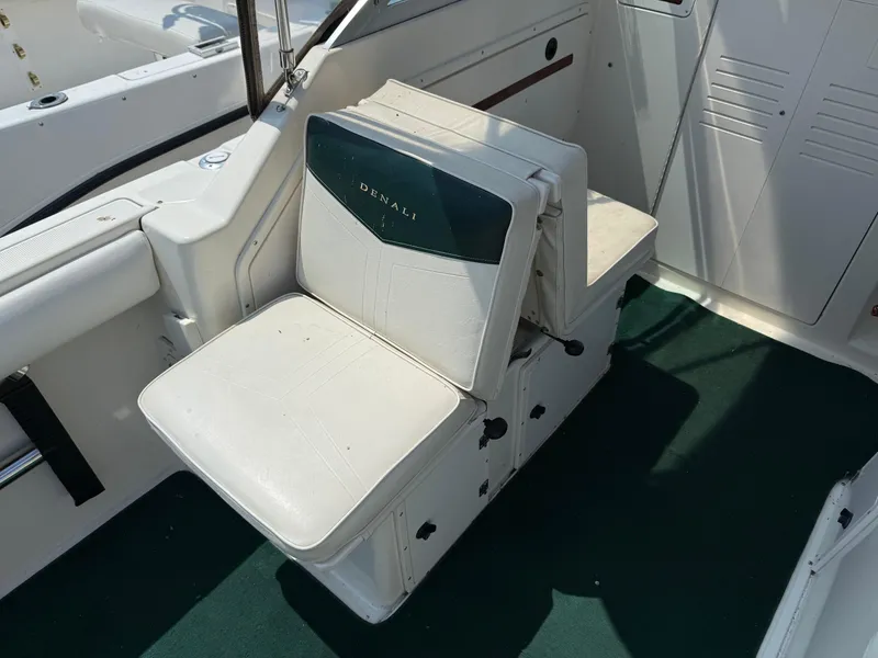 Slide: The Image of 1996 Pursuit 2460 Denali boat seat with green and white upholstery. - 12