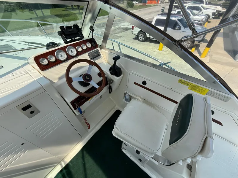 Slide: The Image of Interior view of 1996 Pursuit 2460 Denali boat cockpit with steering wheel and gauges. - 14