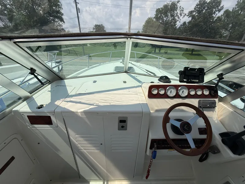 Slide: The Image of 1996 Pursuit 2460 Denali boat dashboard with steering wheel and instrument panel. - 17