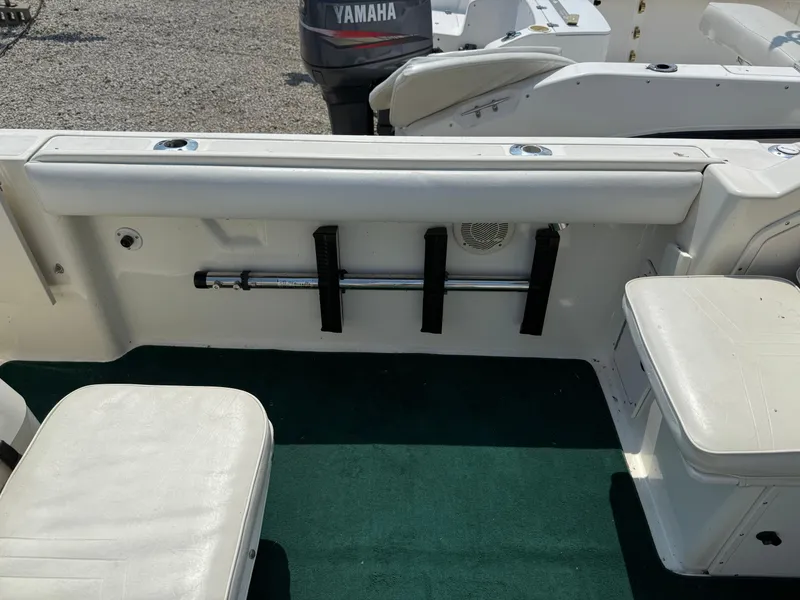 Slide: The Image of 1996 Pursuit 2460 Denali boat interior with seating and rod holder. - 21