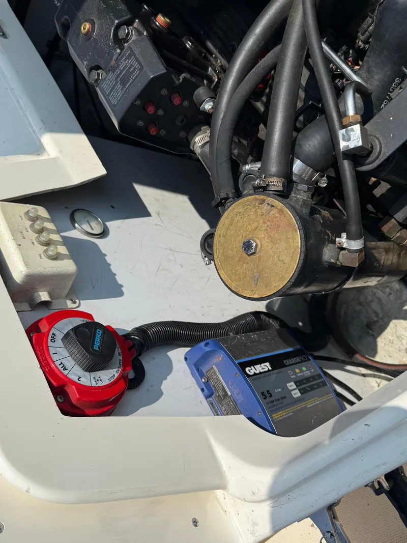 Slide: The Image of Engine compartment of a 1996 Pursuit 2460 Denali boat with visible components and wiring. - 24