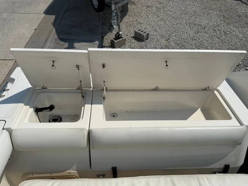 Slide: The Image of Open storage compartments on a 1996 Pursuit 2460 Denali boat. - 26