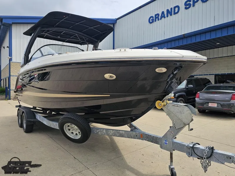 Slide: The Image of 2016 Sea Ray 250 SLX boat on trailer outside Grand Sport Center. - 11