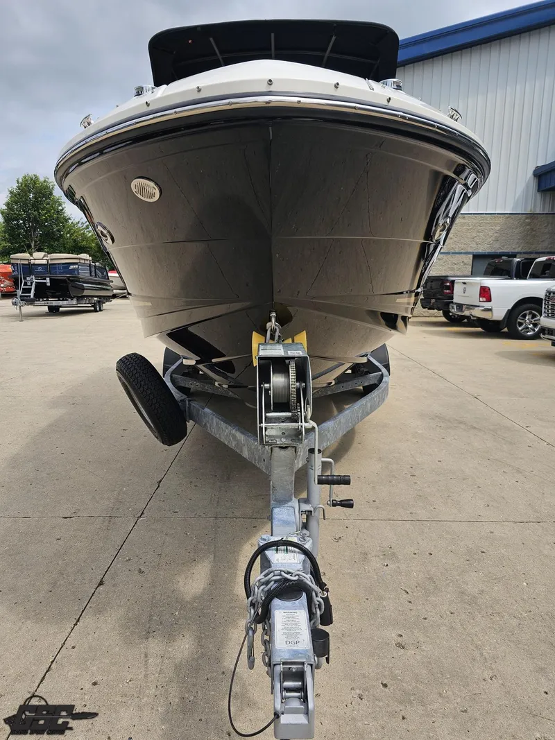 Slide: The Image of 2016 Sea Ray 250 SLX boat on trailer in parking lot. - 12