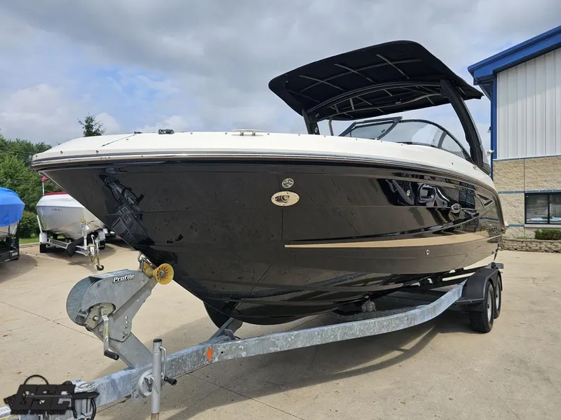 Slide: The Image of 2016 Sea Ray 250 SLX boat on trailer, parked outdoors near a building. - 14