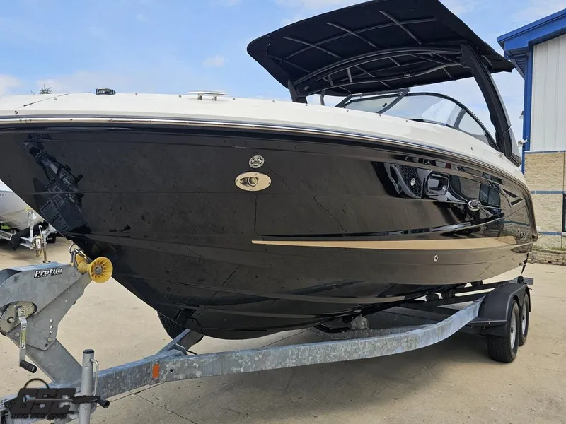 Slide: The Image of 2016 Sea Ray 250 SLX boat on trailer, black hull, outdoor setting. - 15