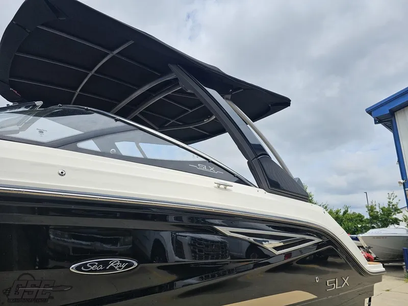 Slide: The Image of 2016 Sea Ray 250 SLX boat with sleek black and white design under cloudy sky. - 19
