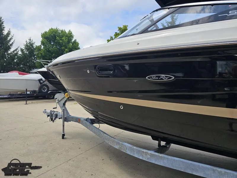 Slide: The Image of 2016 Sea Ray 250 SLX boat on trailer, black exterior, parked outdoors. - 20