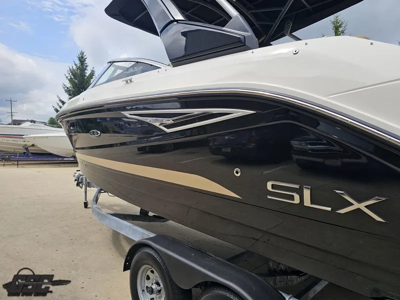 Slide: The Image of 2016 Sea Ray 250 SLX boat on trailer, sleek black and white design. - 21